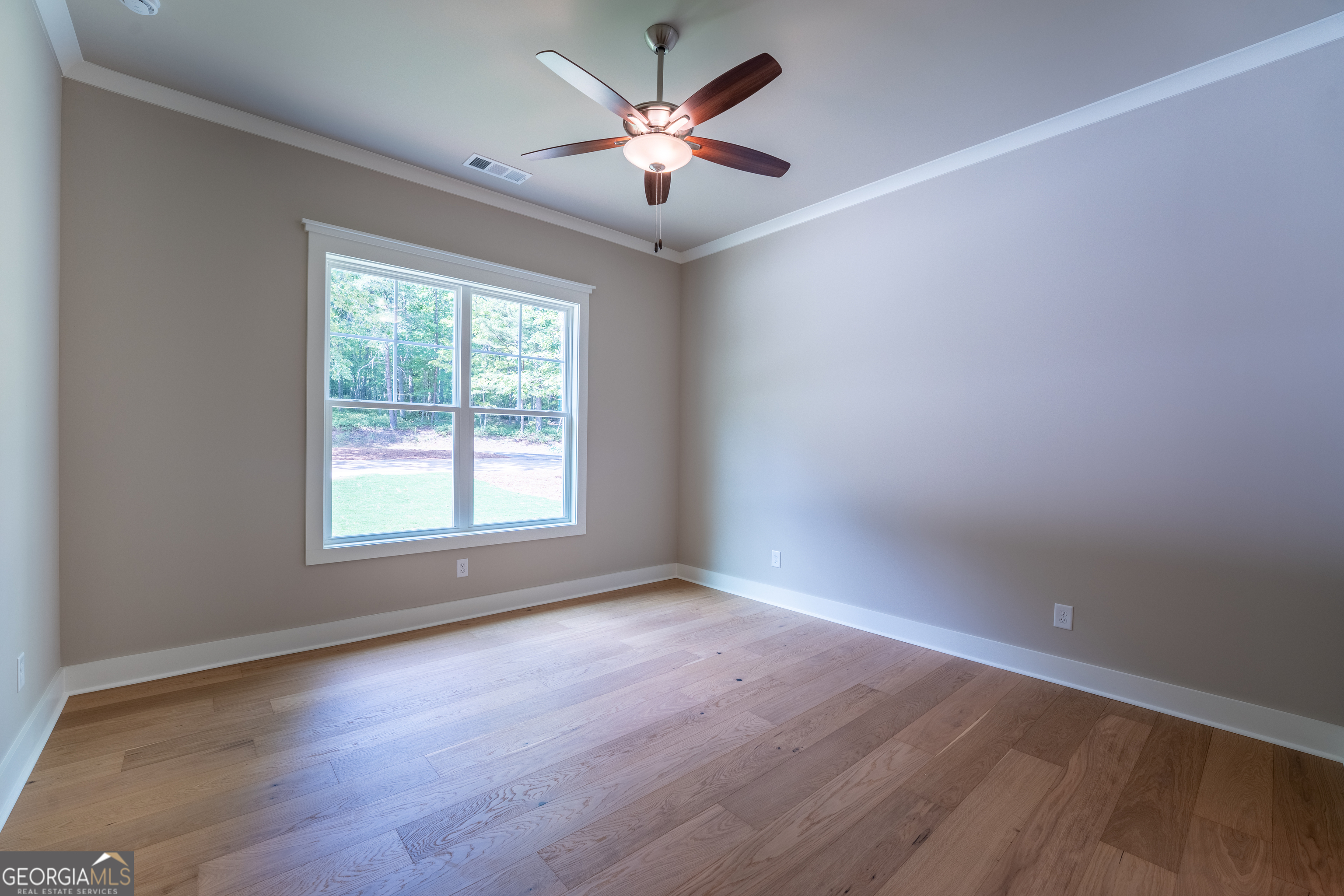 120 Fall Pippin Court Clarkesville, GA 30523 - Photo 41 of 65 an empty room with wooden floor and windows