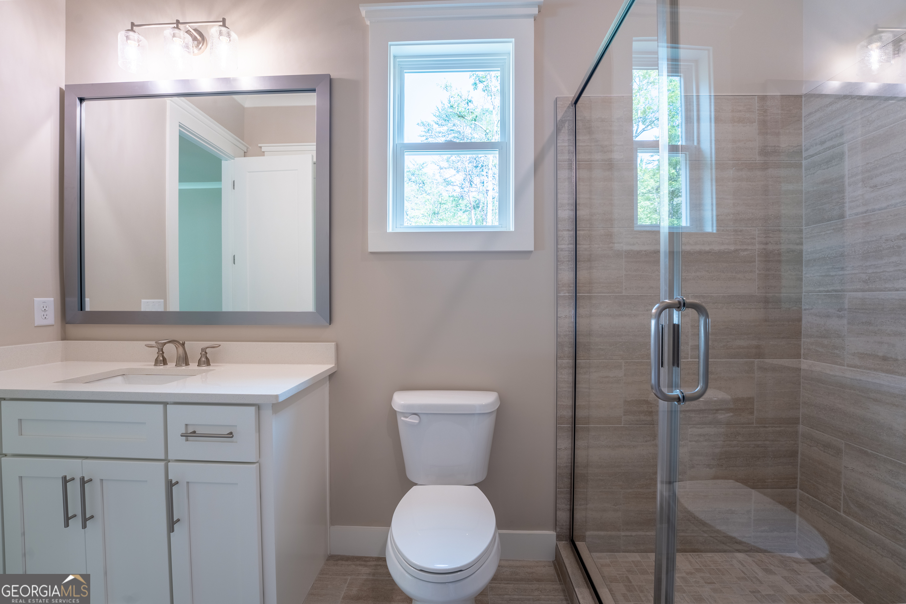 120 Fall Pippin Court Clarkesville, GA 30523 - Photo 46 of 65 a bathroom with a toilet a sink and mirror