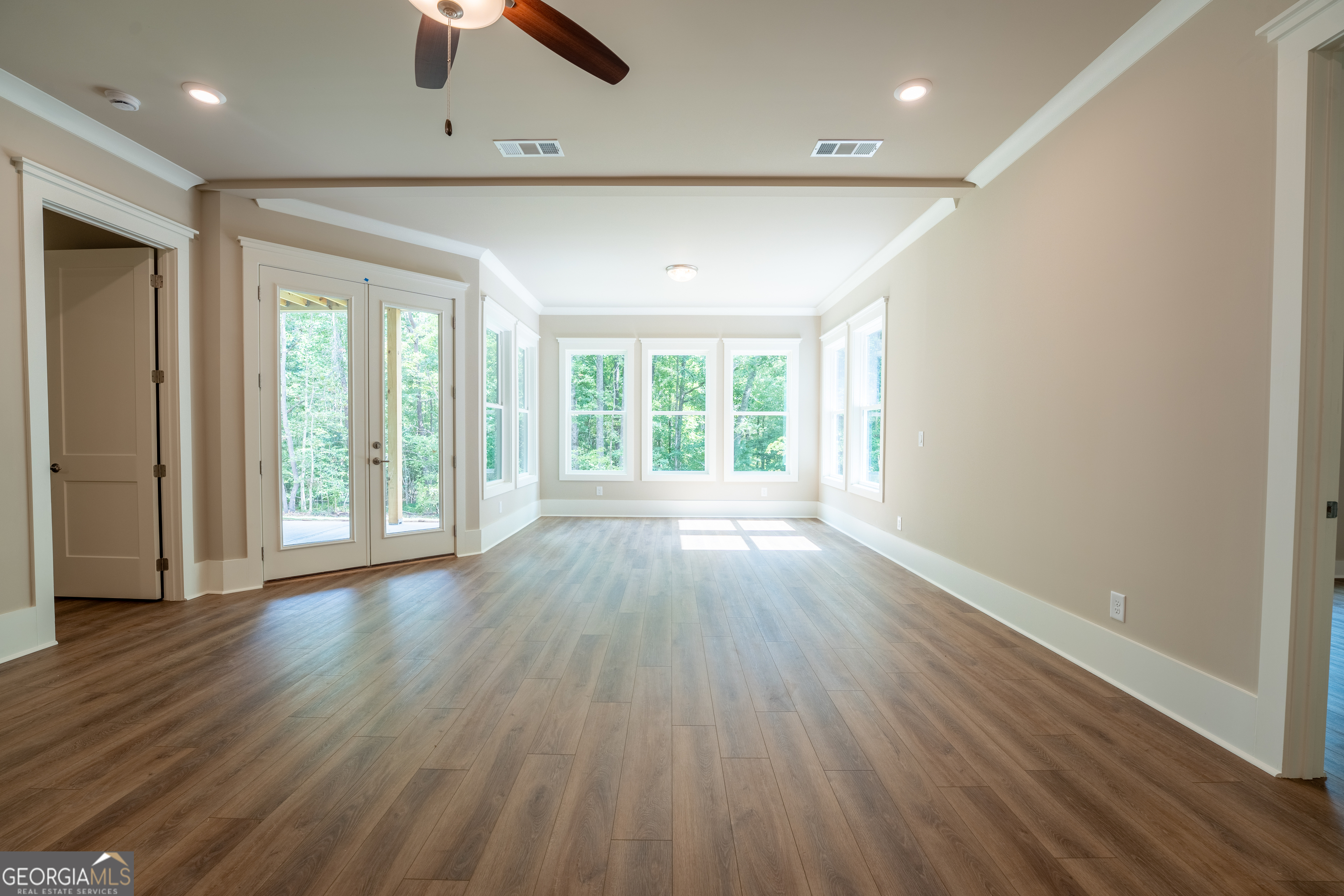 120 Fall Pippin Court Clarkesville, GA 30523 - Photo 49 of 65 an empty room with wooden floor and windows