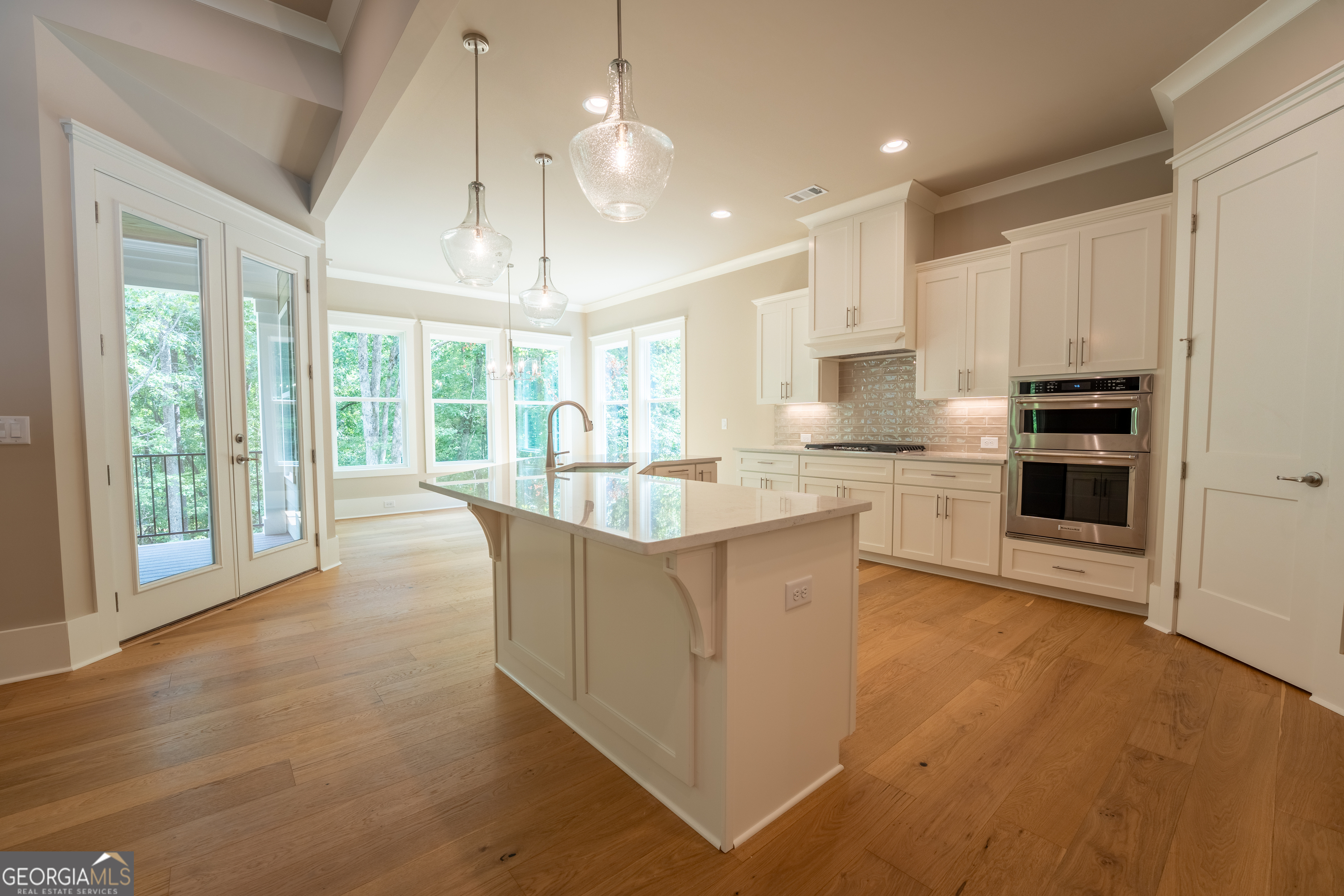 120 Fall Pippin Court Clarkesville, GA 30523 - Photo 10 of 65 a kitchen with stainless steel appliances granite countertop a stove top oven a refrigerator a sink and a dining table with wooden floor