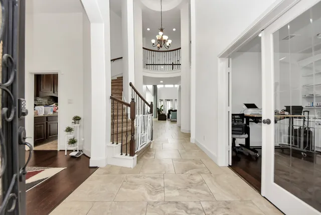 a view of a hallway with wooden floor and staircase