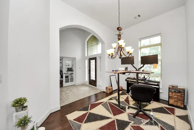 a view of a dining room with furniture and chandelier