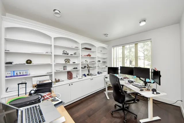 a view of a workspace with furniture and a window