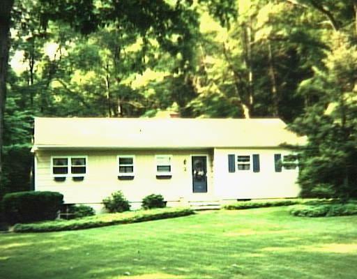 29 Arrowhead Road Wilton, CT 06897 - Photo 1 of 1 a view of a white house with a big yard and large trees
