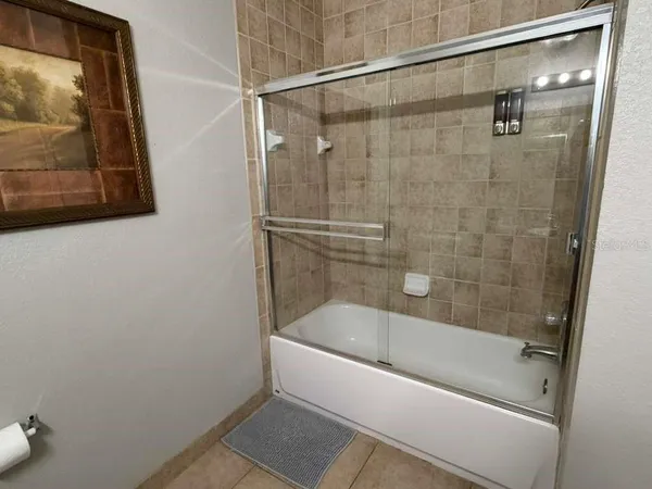 a white bath tub sitting next to a white sink and vanity