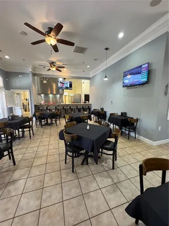 a living room with lots of furniture and kitchen view