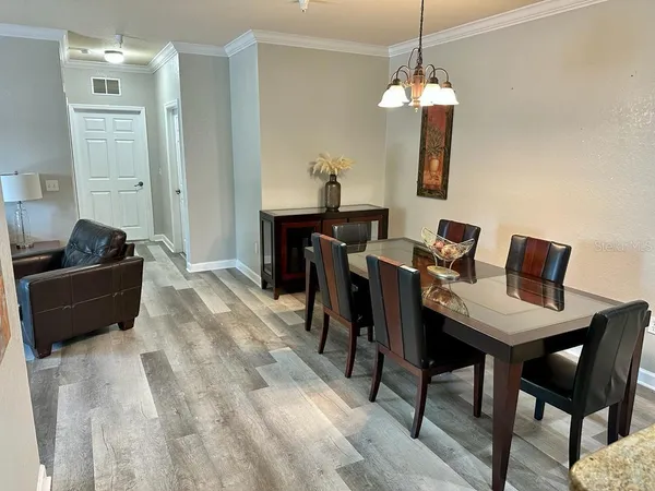a living room with furniture and a chandelier
