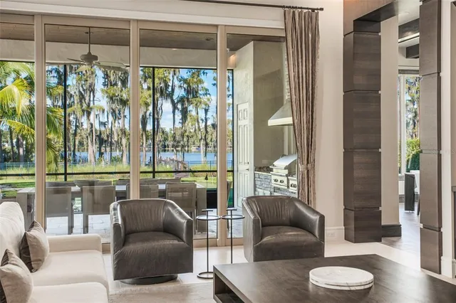 a living room with kitchen island granite countertop wooden floor and stainless steel appliances