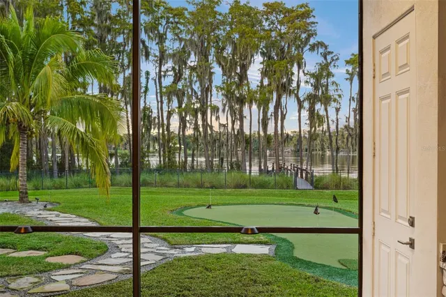 a front view of building with yard and trees