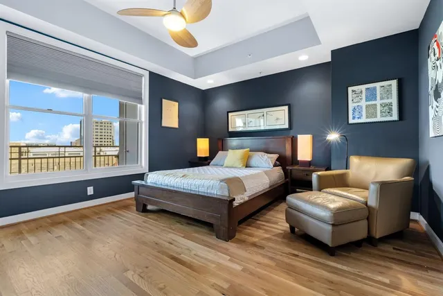 a bedroom with a large bed and a chandelier