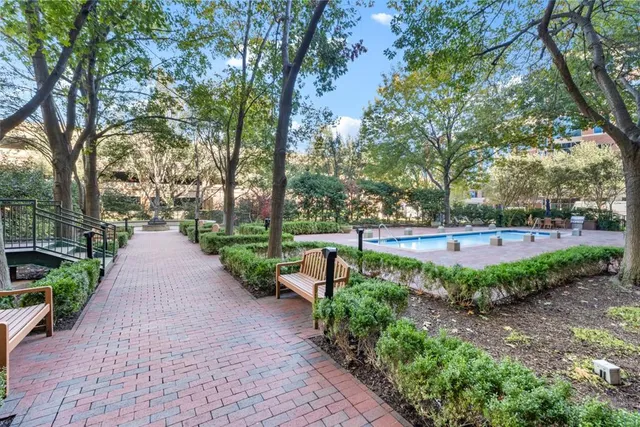 a view of a house with a small yard and a fountain