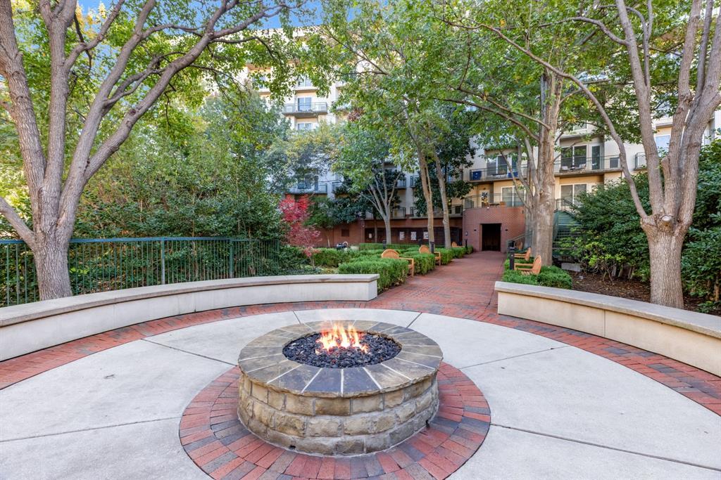 5055 Addison Circle, Unit 733 Addison, TX 75001 - Photo 24 of 40 a view of a house with a small yard and a fountain