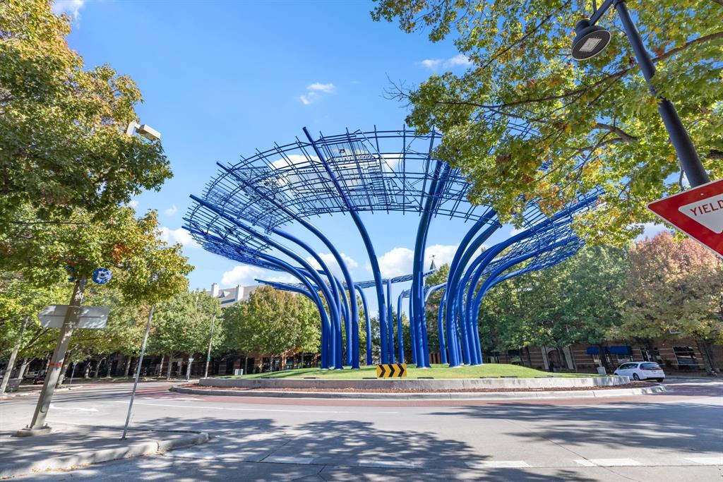 5055 Addison Circle, Unit 733 Addison, TX 75001 - Photo 32 of 40 a building with trees in the background