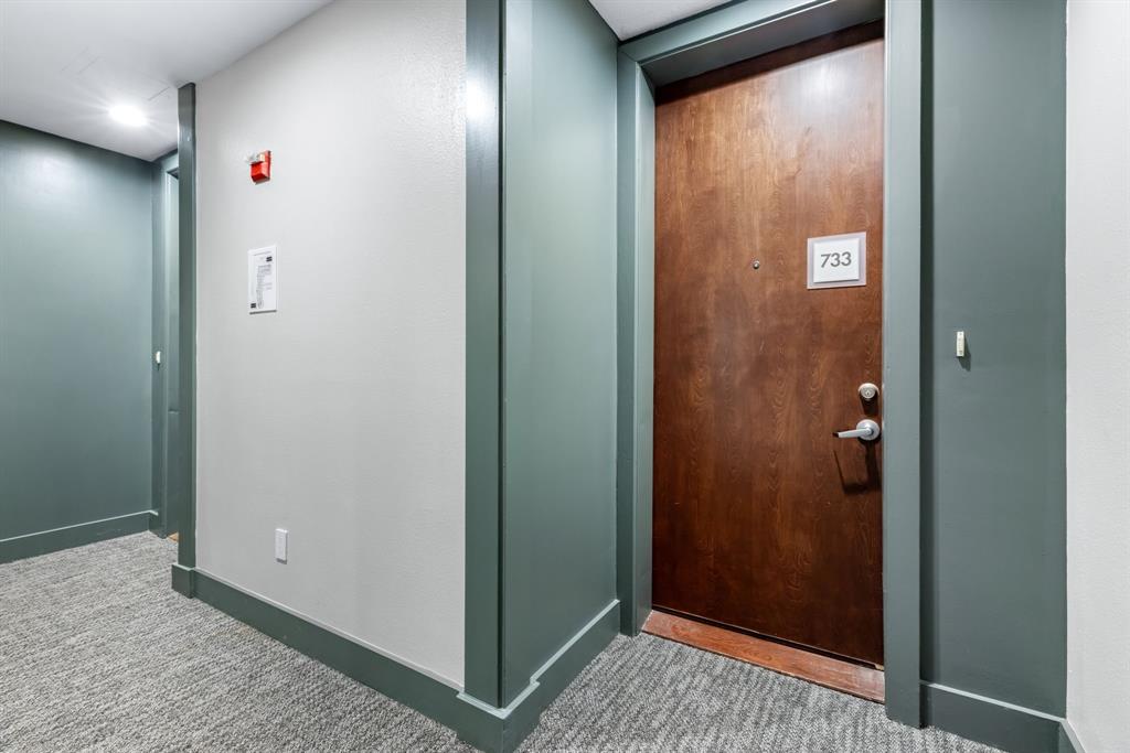 5055 Addison Circle, Unit 733 Addison, TX 75001 - Photo 4 of 40 a view of a hallway with a glass door