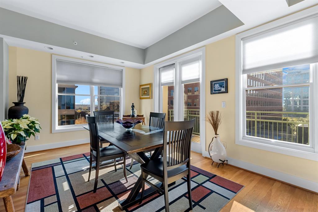 5055 Addison Circle, Unit 733 Addison, TX 75001 - Photo 7 of 40 a view of a dining room with furniture window and wooden floor