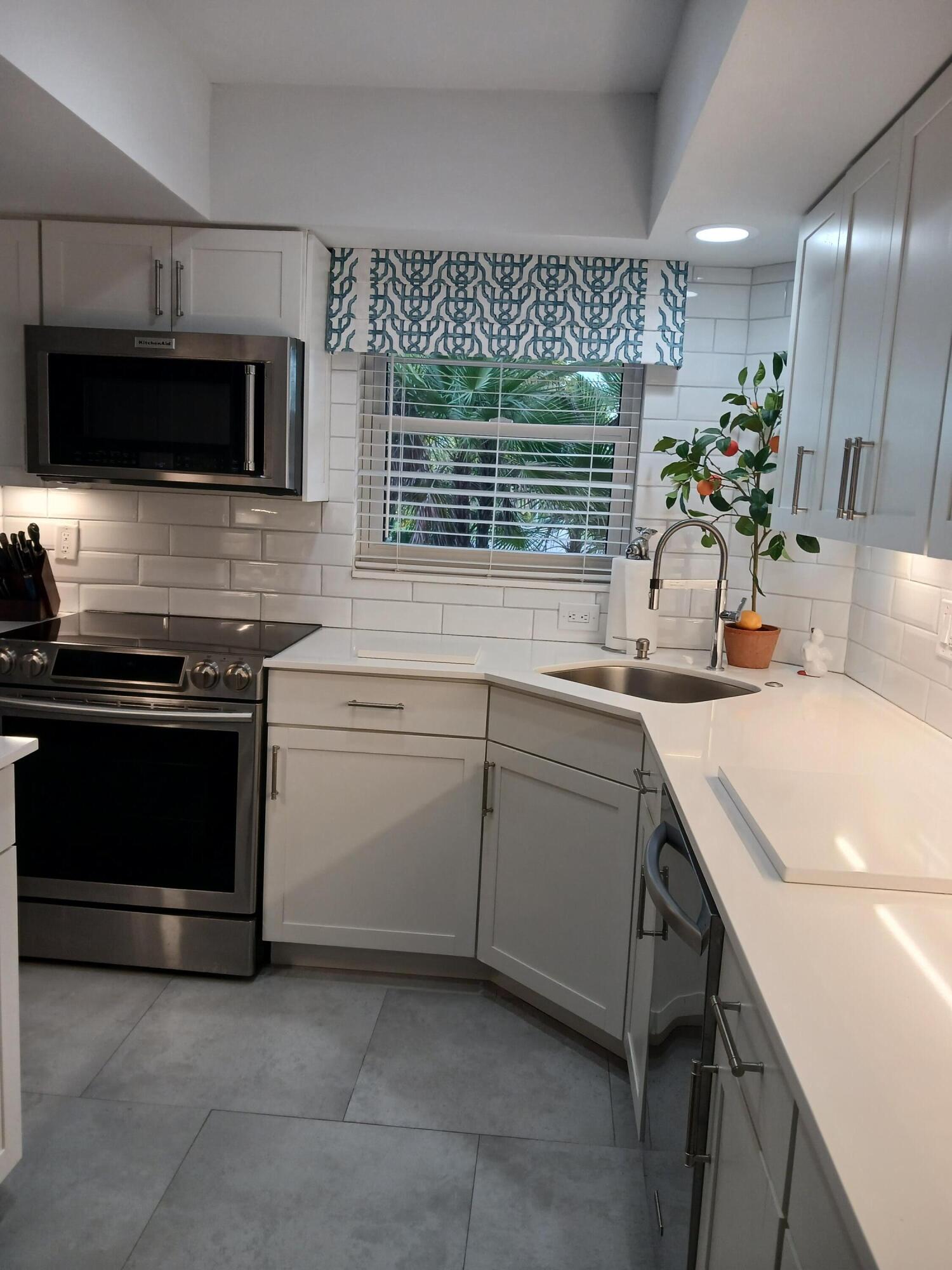 a kitchen with a sink stove and microwave