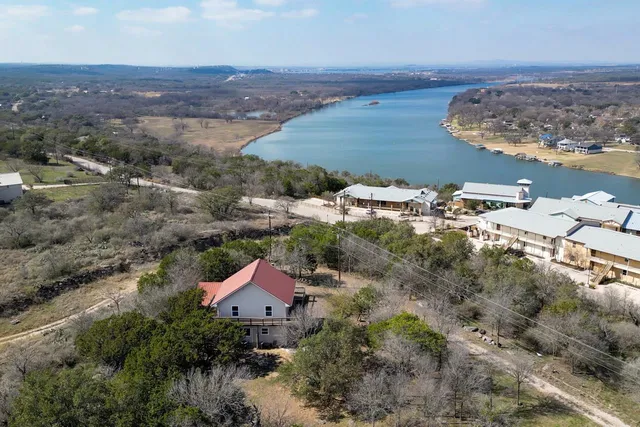 an aerial view of a house with a yard