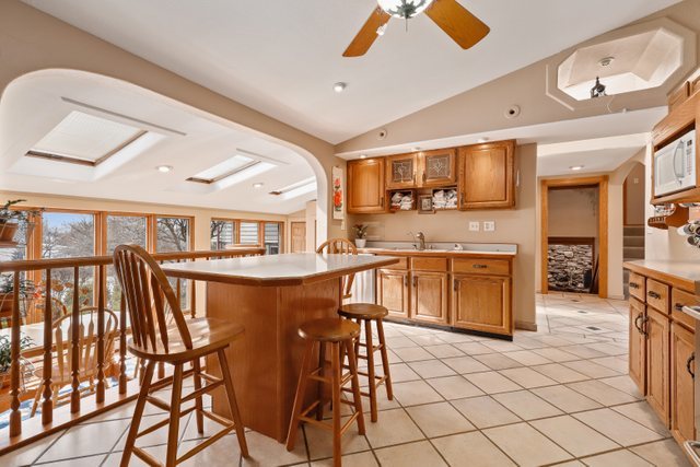 2202 Stieg Road Woodstock, IL 60098 - Photo 8 of 55 a kitchen with stainless steel appliances kitchen island granite countertop a stove a sink and a refrigerator