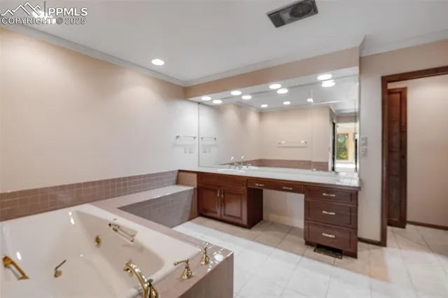 a spacious bathroom with a granite countertop sink a mirror and a bathtub