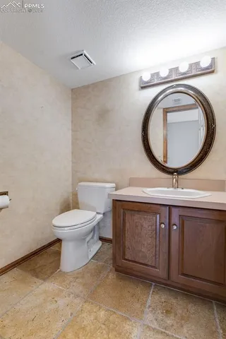 a kitchen with granite countertop a sink counter top space and stainless steel appliances