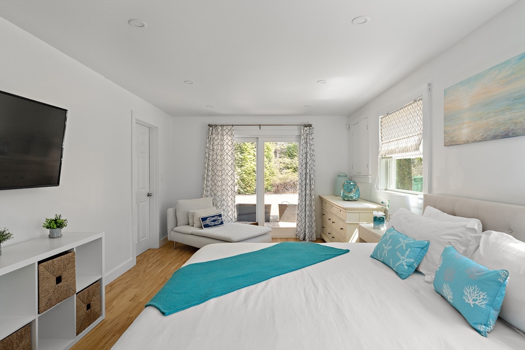 13 Young Street Edgartown, MA 02539 - Photo 17 of 29 a bedroom with a large bed and a flat screen tv