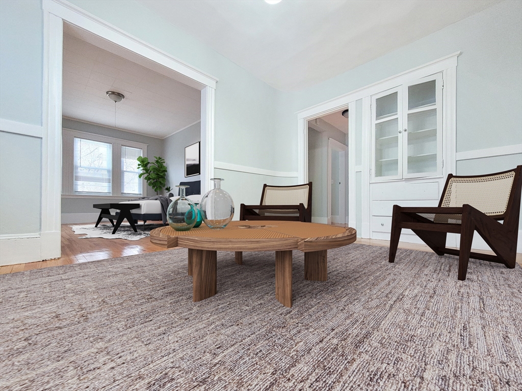 31-35 Juniper Street, Unit 31 1 Boston, MA 02119 - Photo 1 of 12 a living room with furniture a rug and a table