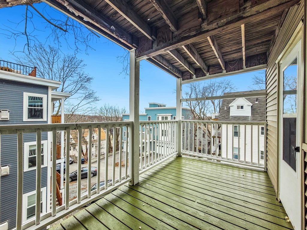 31-35 Juniper Street, Unit 31 1 Boston, MA 02119 - Photo 11 of 12 a view of balcony with wooden floor