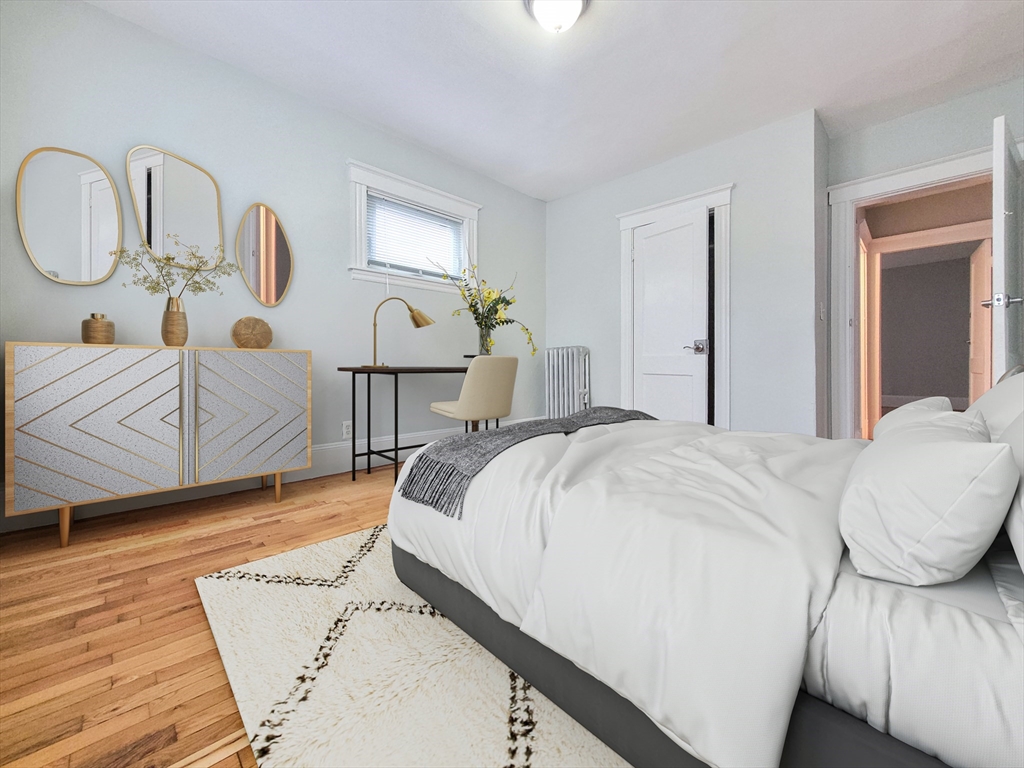 31-35 Juniper Street, Unit 31 1 Boston, MA 02119 - Photo 5 of 12 a bedroom with a bed couch and dresser
