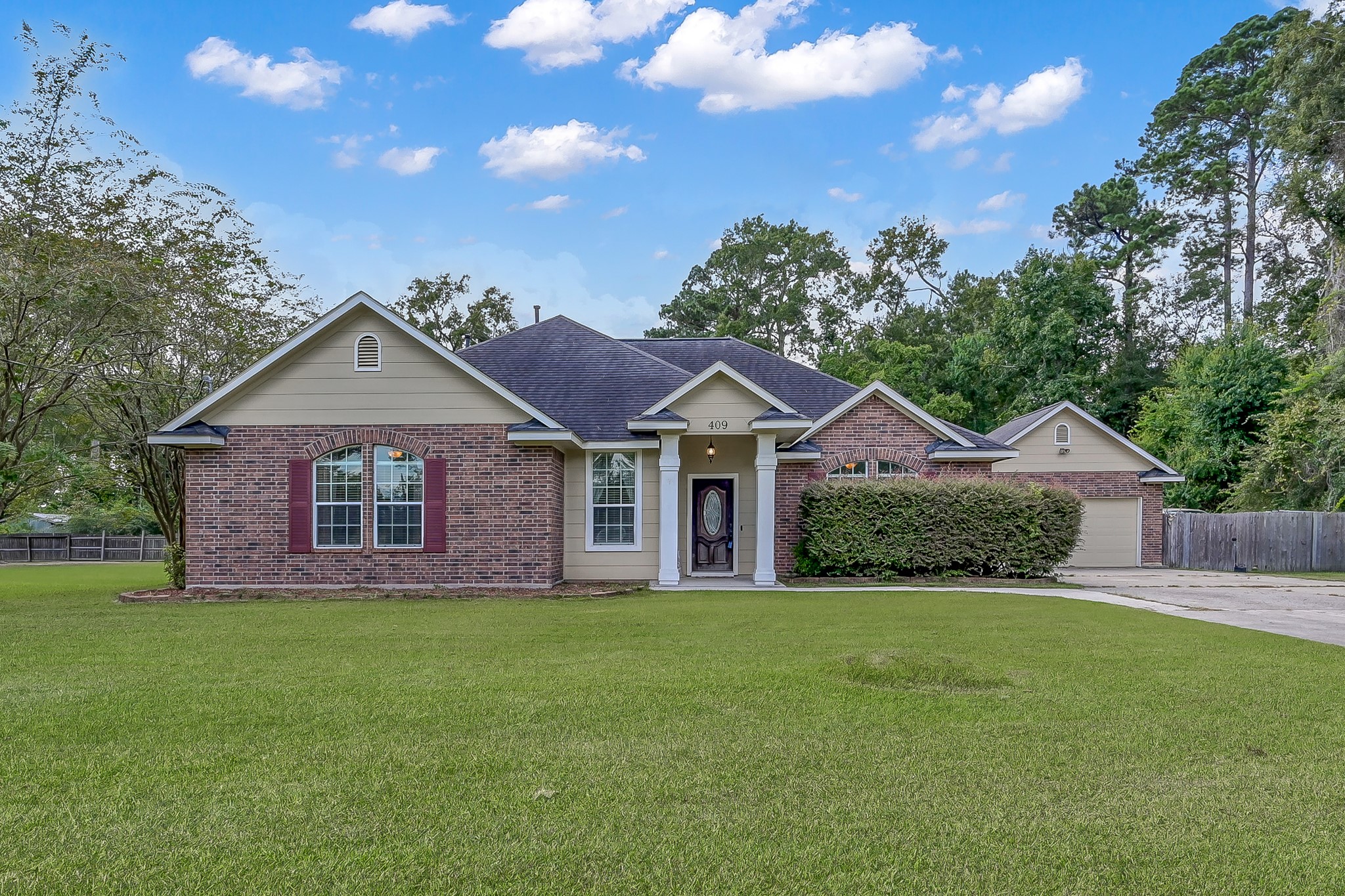 409 Mildred Street Cleveland, TX 77328 - Photo 1 of 24 a view of a house with yard and a garden