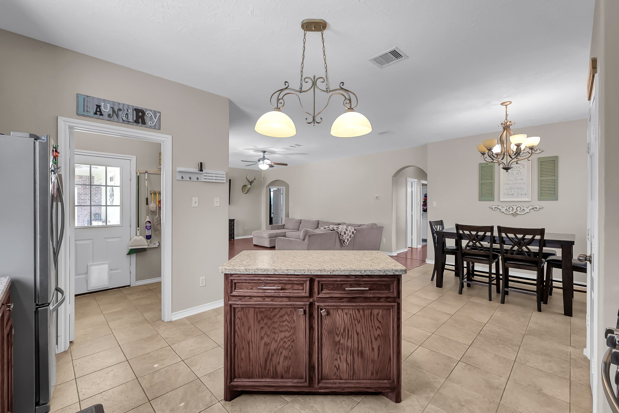 409 Mildred Street Cleveland, TX 77328 - Photo 10 of 24 a view of a dining room with furniture and chandelier