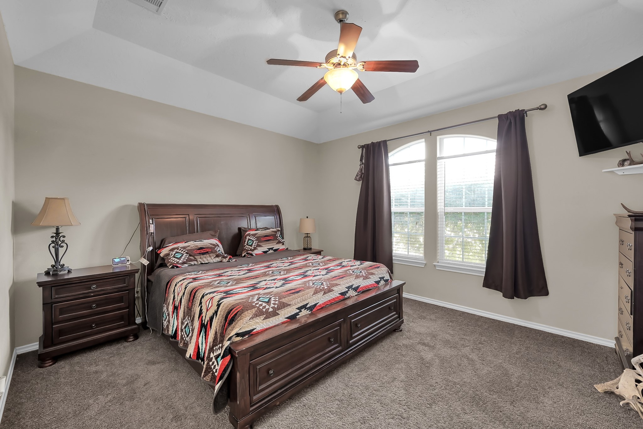 409 Mildred Street Cleveland, TX 77328 - Photo 11 of 24 a bedroom with a bed chandelier and a window
