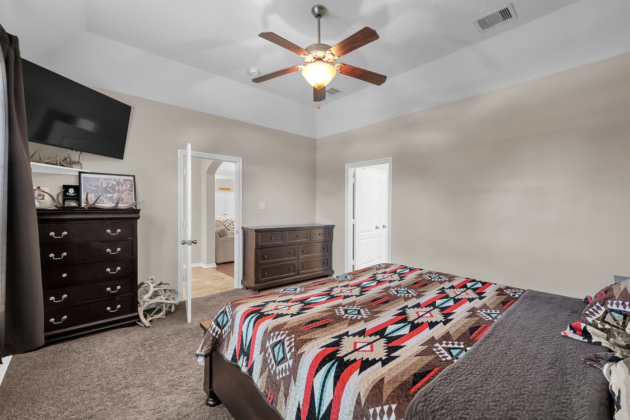 409 Mildred Street Cleveland, TX 77328 - Photo 12 of 24 a bedroom with a bed and a flat screen tv