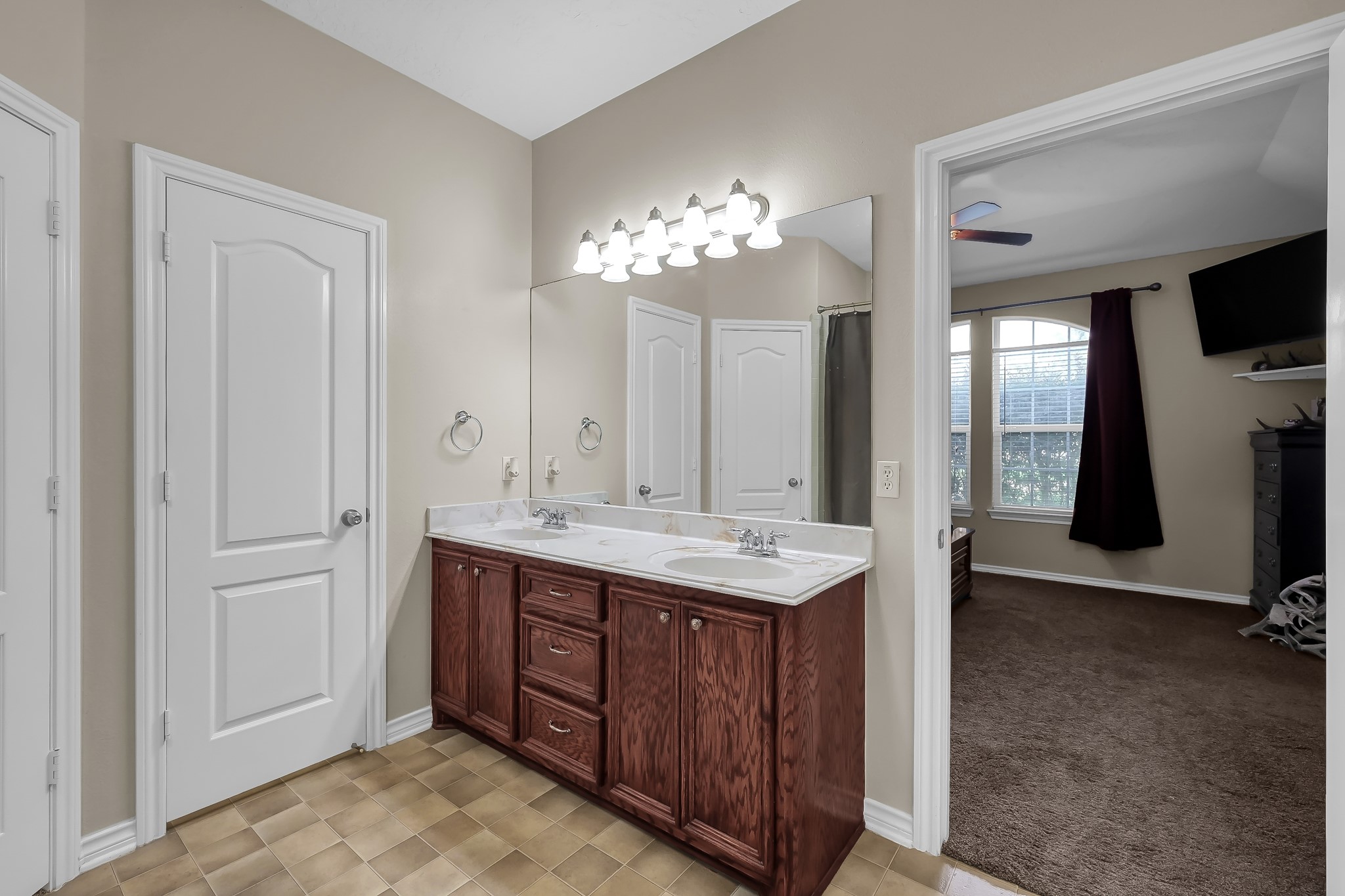409 Mildred Street Cleveland, TX 77328 - Photo 13 of 24 a bathroom with a double vanity sink and a mirror