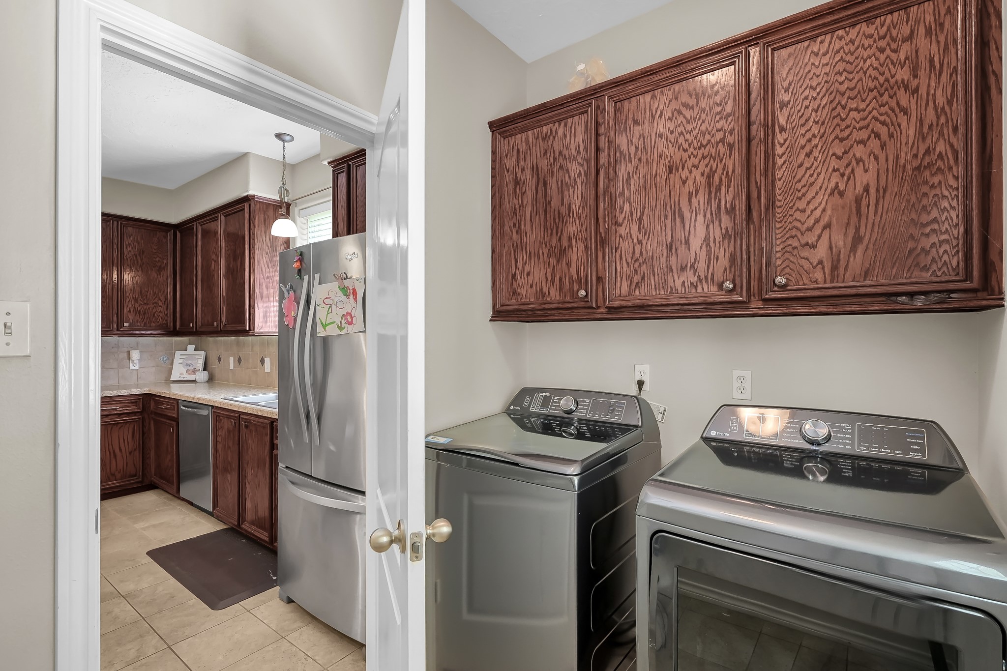 409 Mildred Street Cleveland, TX 77328 - Photo 18 of 24 a kitchen with stainless steel appliances granite countertop a refrigerator sink and stove