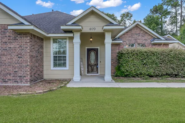 a front view of a house with a yard