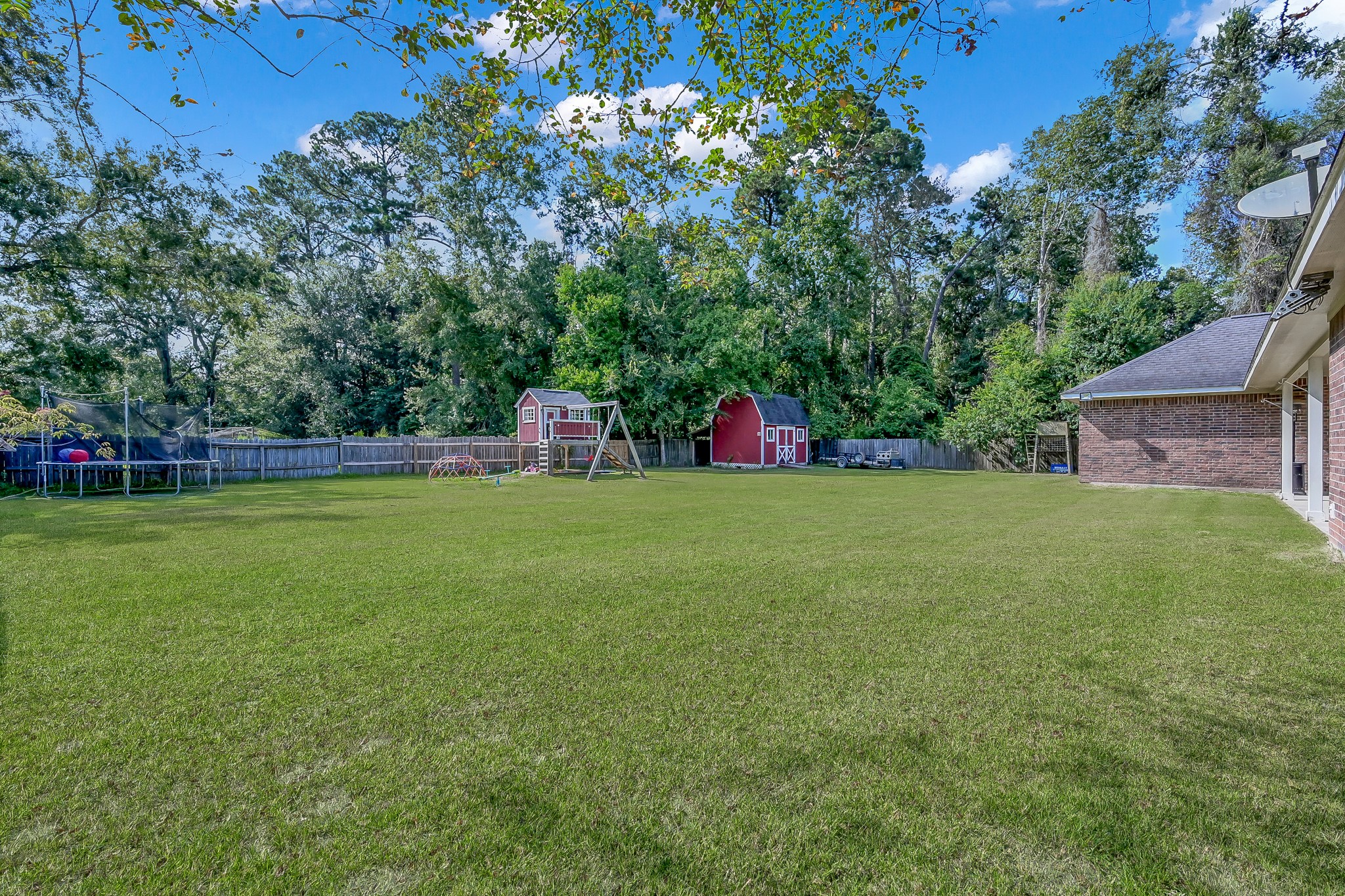 409 Mildred Street Cleveland, TX 77328 - Photo 20 of 24 a view of a house with a backyard