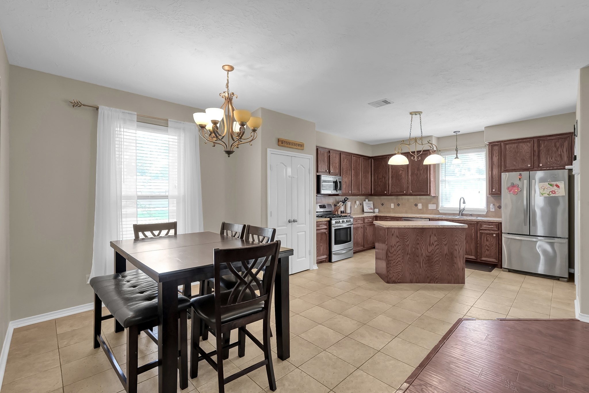 409 Mildred Street Cleveland, TX 77328 - Photo 6 of 24 a dining room filled chandelier and kitchen view