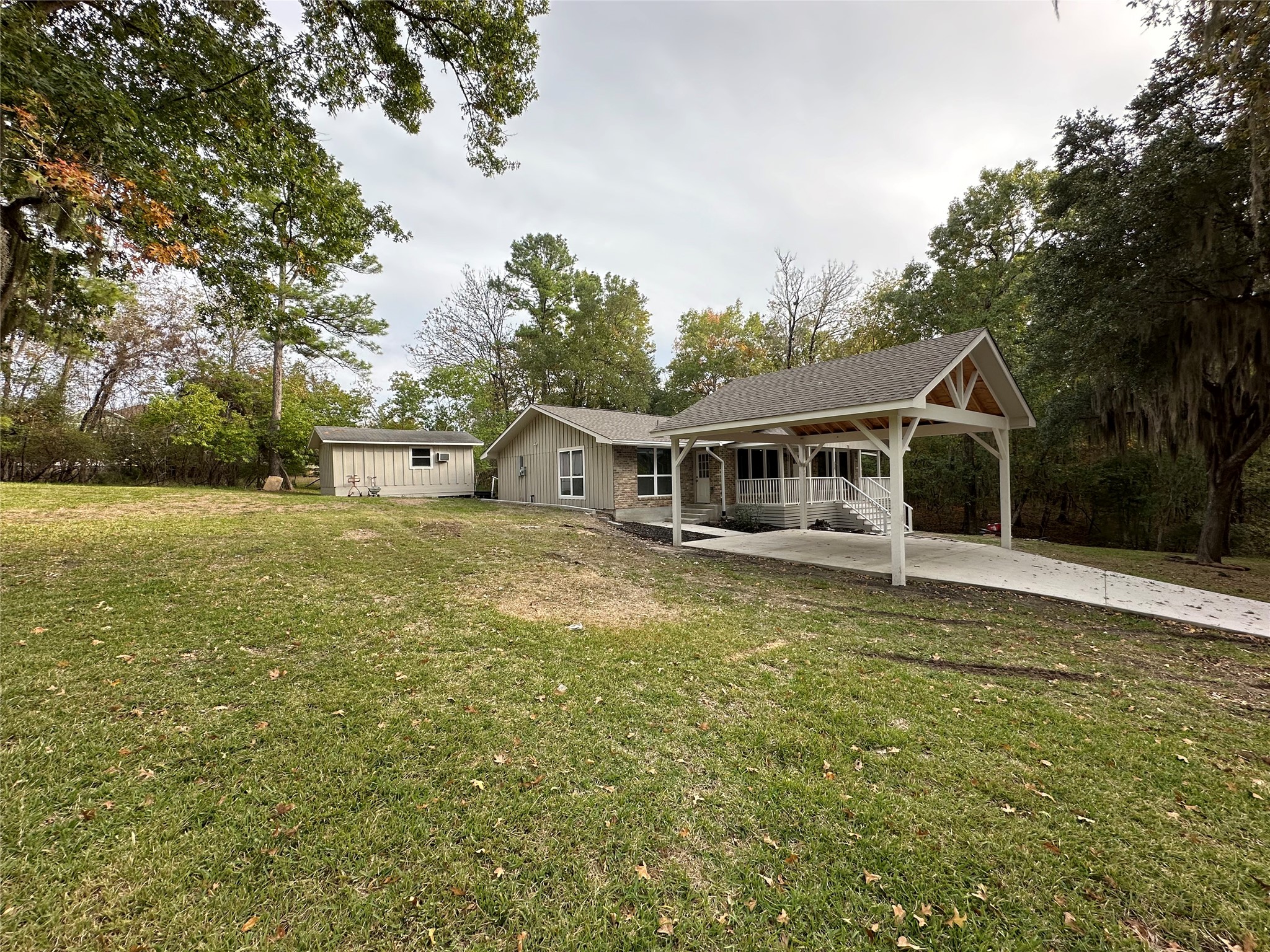 71 Castaway Lane Coldspring, TX 77331 - Photo 3 of 15 Side view with a large yard space of 16,000 SqFt