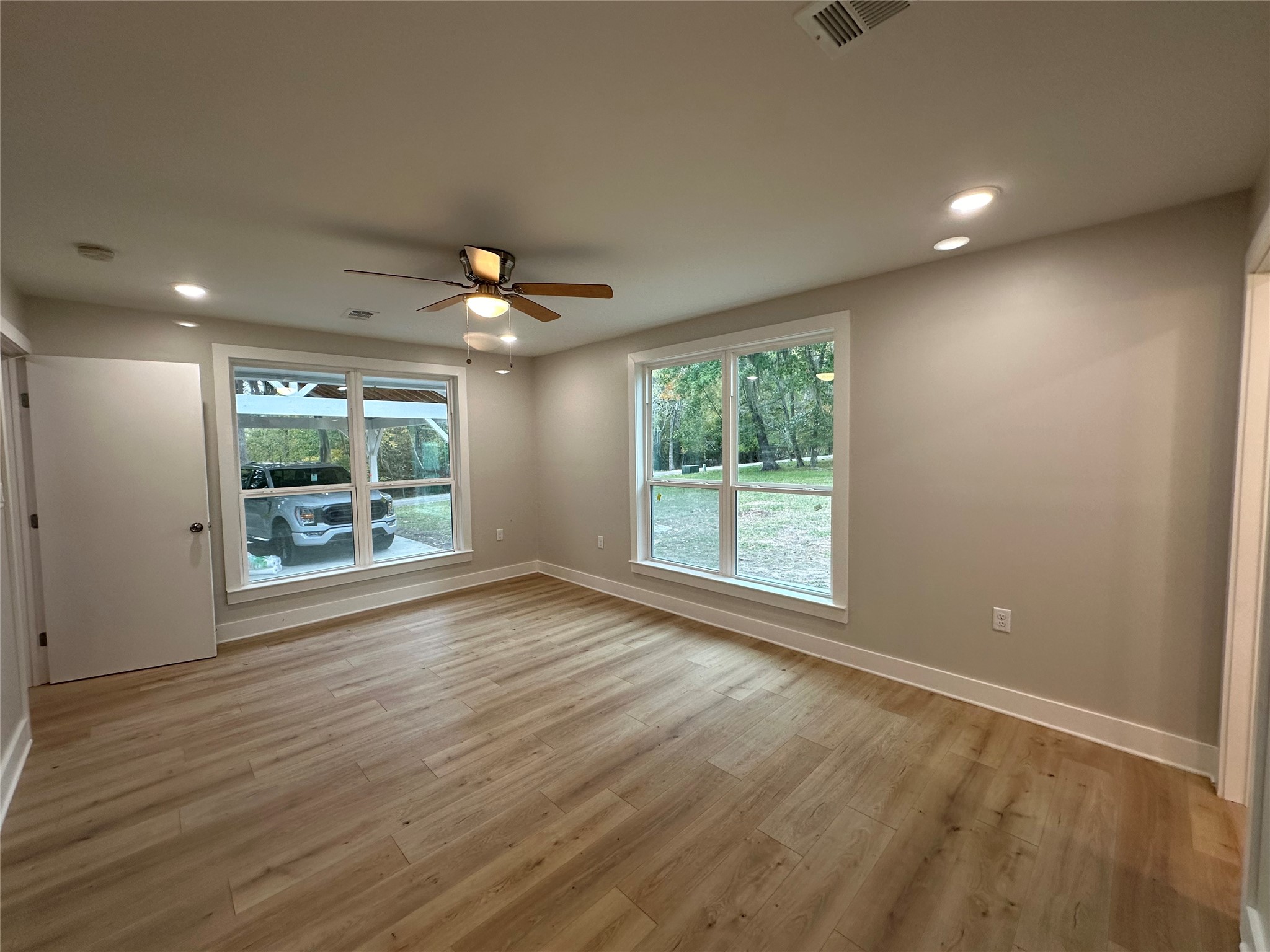 71 Castaway Lane Coldspring, TX 77331 - Photo 8 of 15 Primary Bedroom with vastwindow views to the beautiful outdoor space