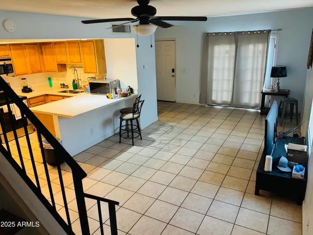 a room with gym equipment and large windows