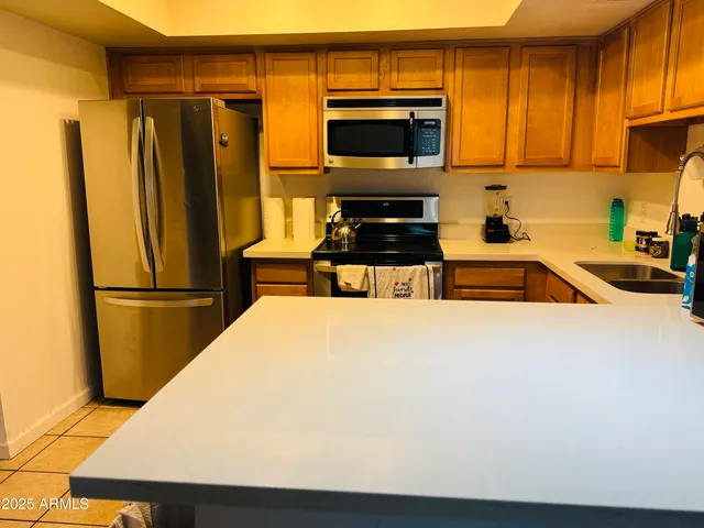 a kitchen with a refrigerator and a sink