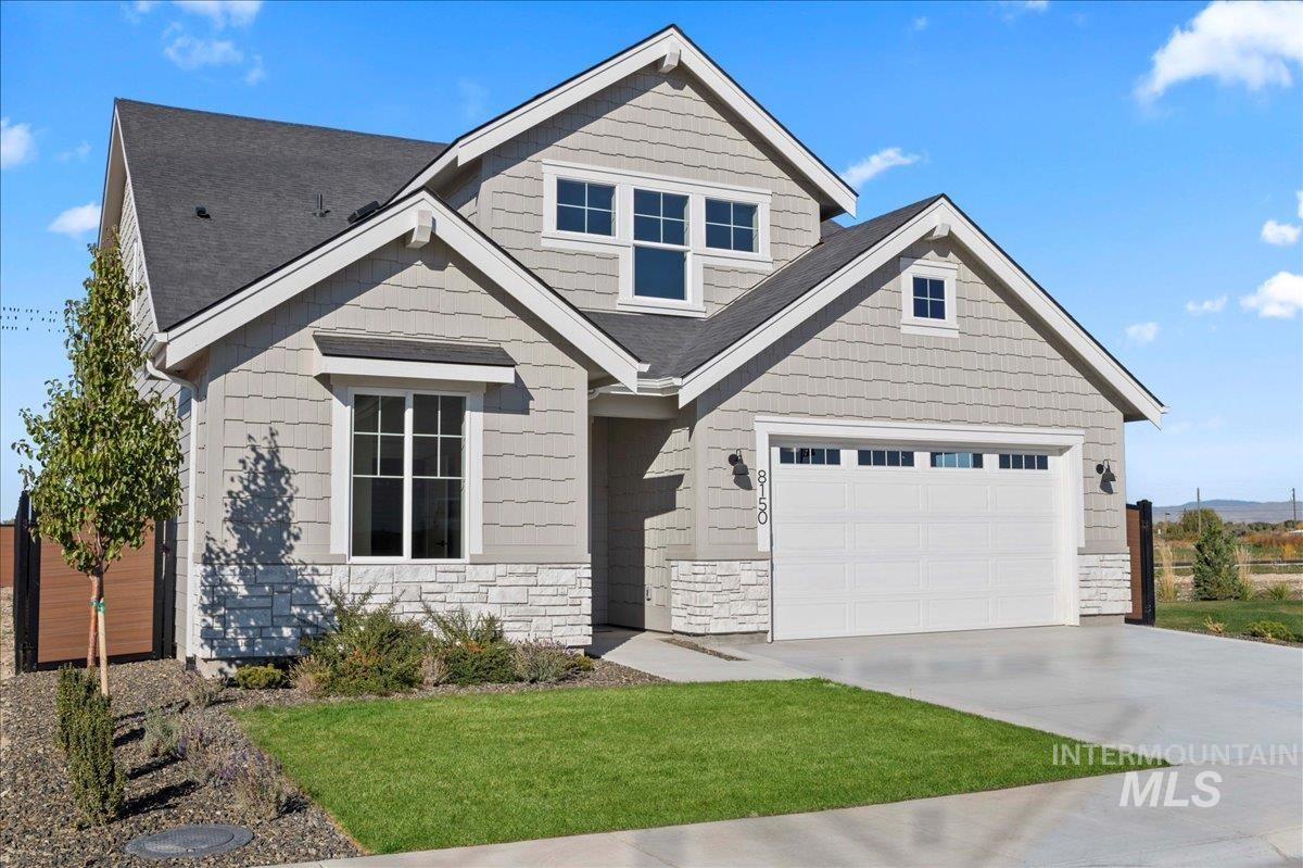 8150 West Gallup Street Meridian, ID 83646 - Photo 1 of 30 Craftsman house featuring driveway, stone siding, and a front yard
