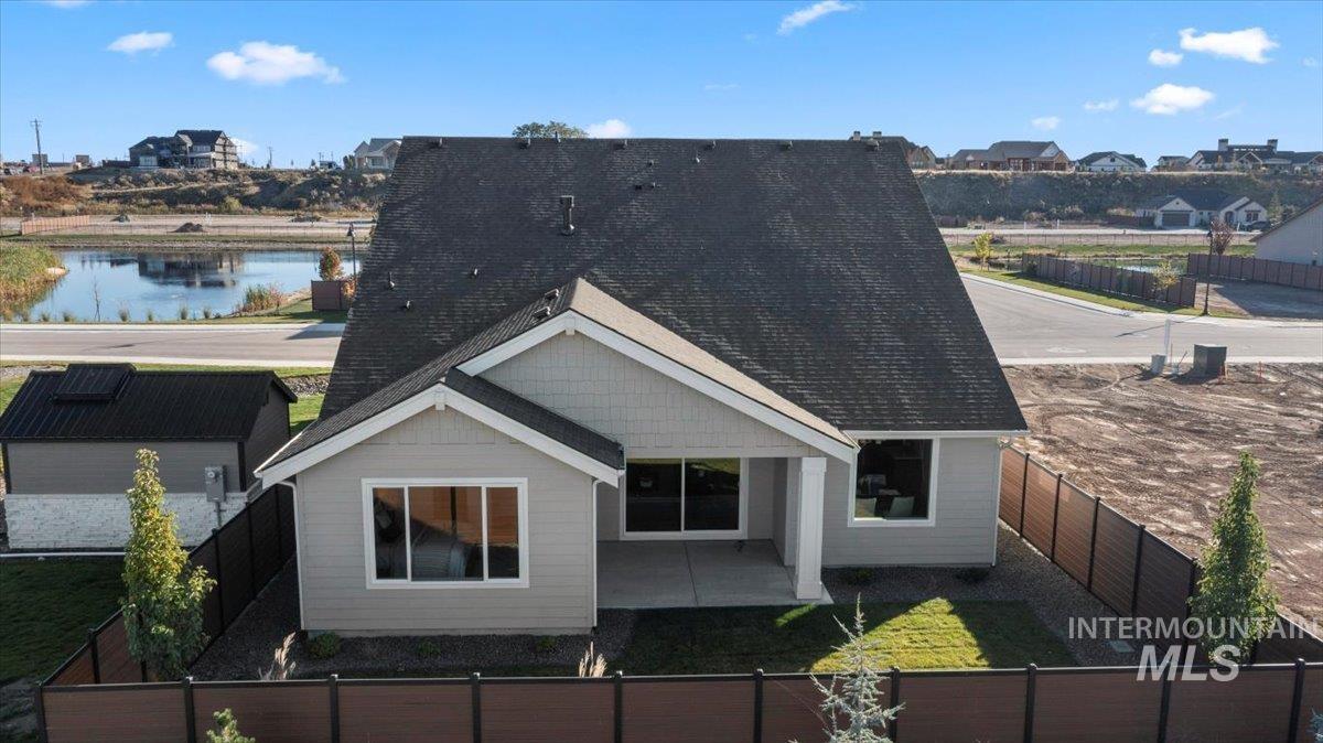 8150 West Gallup Street Meridian, ID 83646 - Photo 23 of 30 Back of house featuring a fenced backyard, roof with shingles, and a patio area