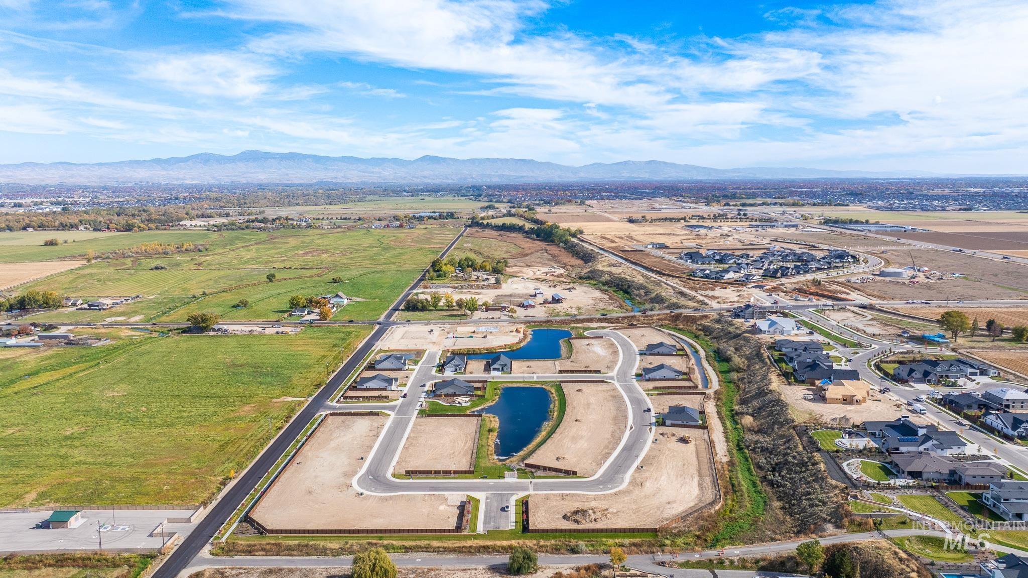 8150 West Gallup Street Meridian, ID 83646 - Photo 26 of 30 Aerial view of property and surrounding area with a water and mountain view