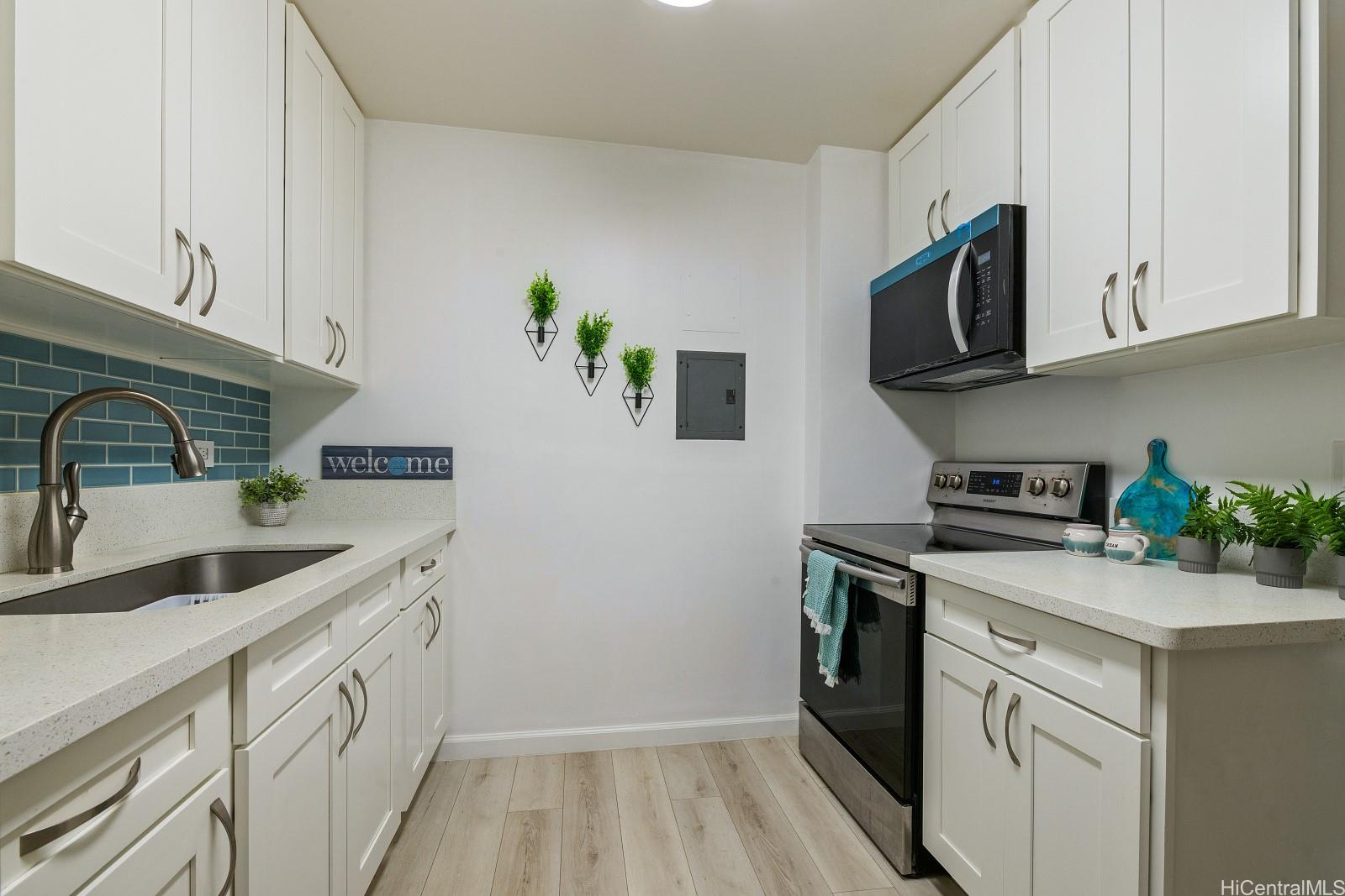 a kitchen with stainless steel appliances granite countertop a sink and a stove top oven