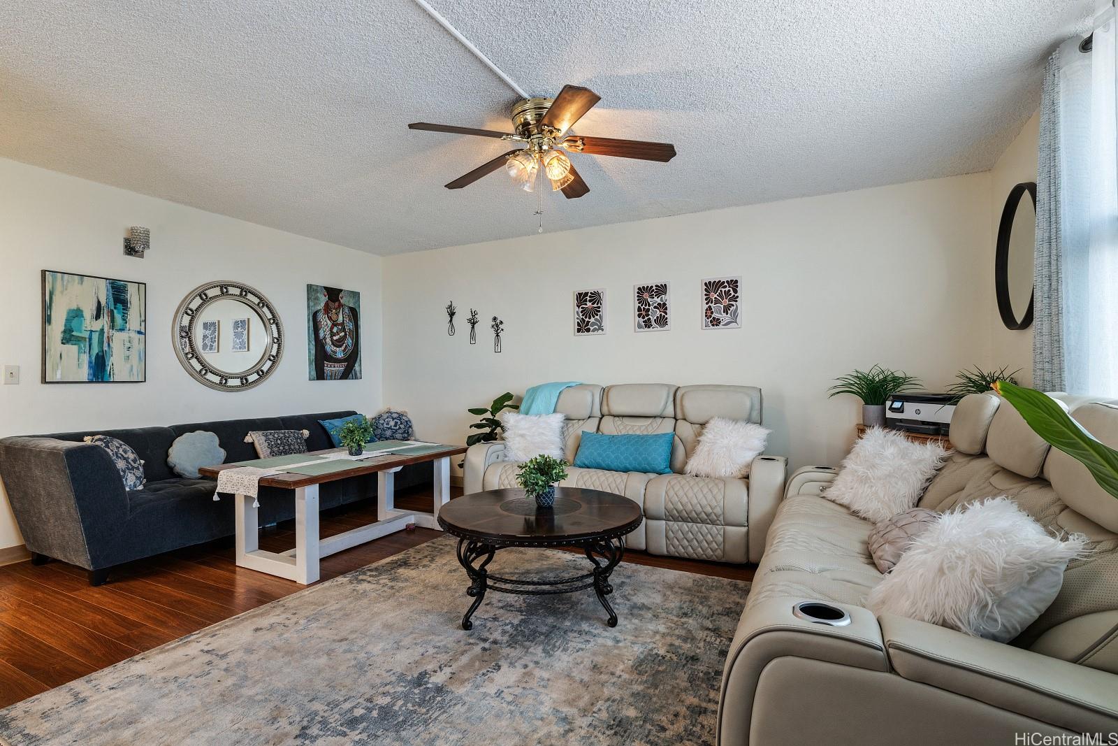 98-1030 Moanalua Road, Unit 5308 Aiea, HI 96701 - Photo 4 of 16 a living room with furniture and a flat screen tv
