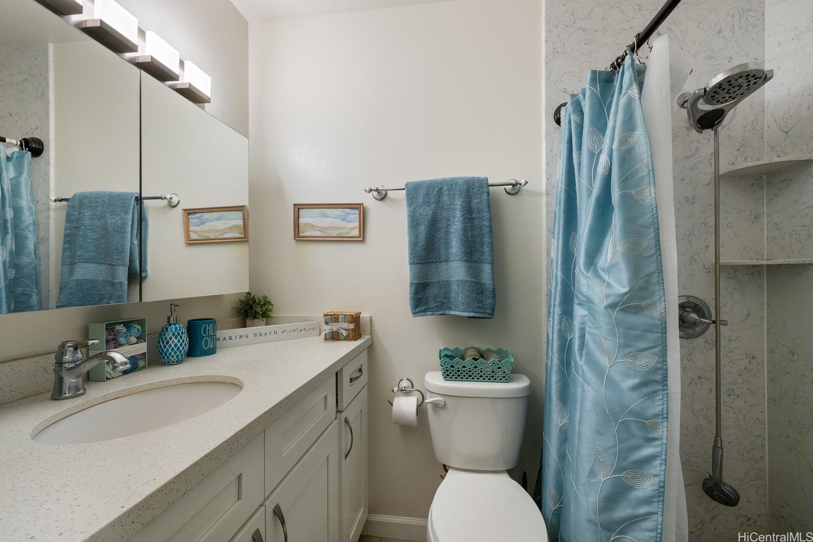 98-1030 Moanalua Road, Unit 5308 Aiea, HI 96701 - Photo 7 of 16 a bathroom with a sink toilet and shower