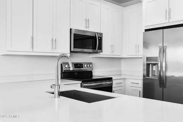 a kitchen with a sink and large window