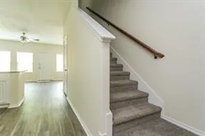 a view of entryway and hall with wooden floor