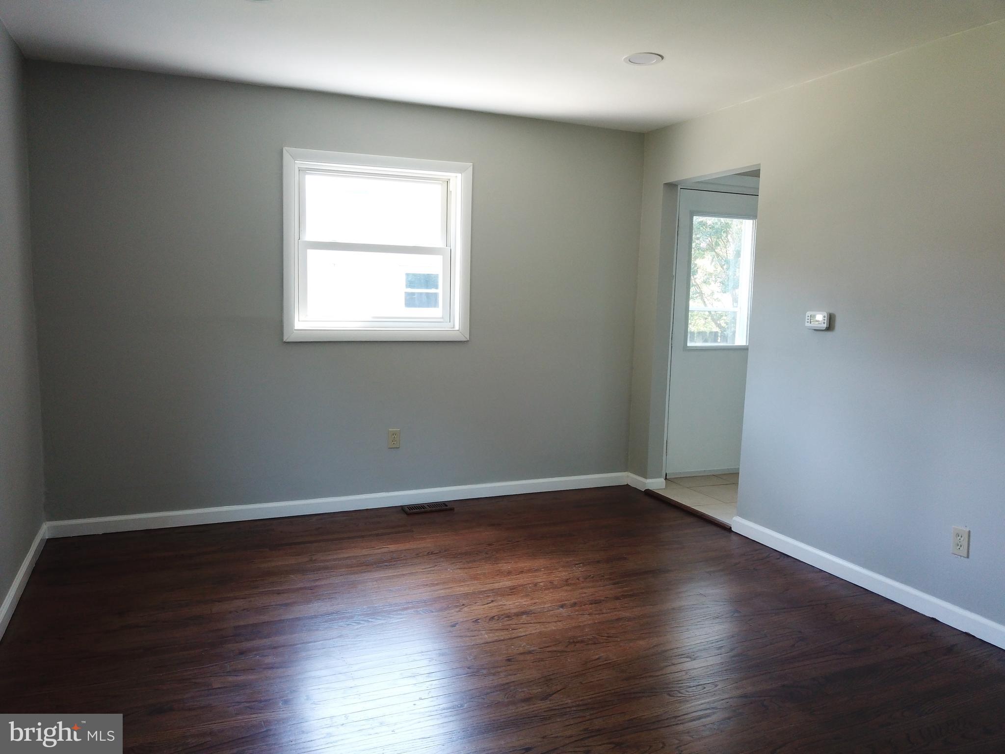 13 Meehan Boulevard Clementon, NJ 08021 - Photo 18 of 32 an empty room with wooden floor and windows